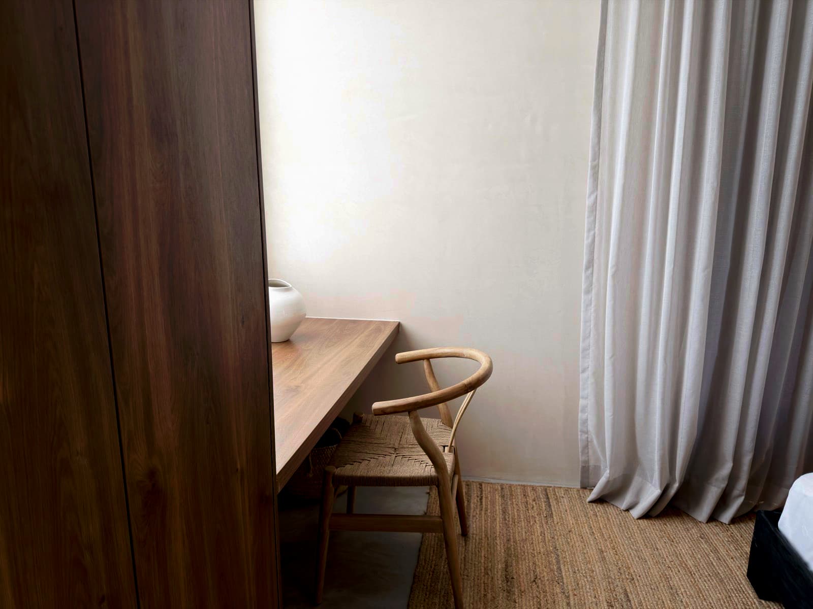 Freshly cleaned bedroom desk nook with a wishbone chair and a walnut wardrobe in Lawrenceville