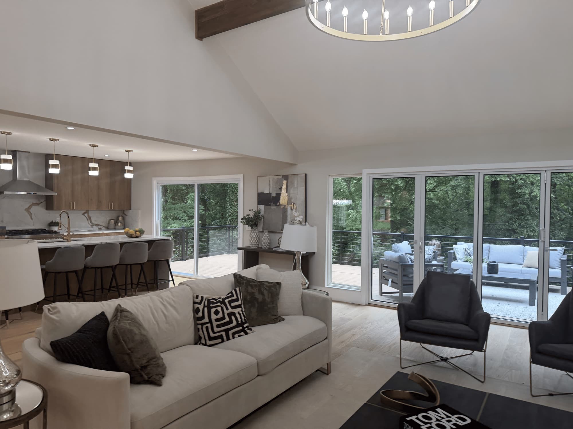 Bright living room with a vaulted ceiling and chandelier after service