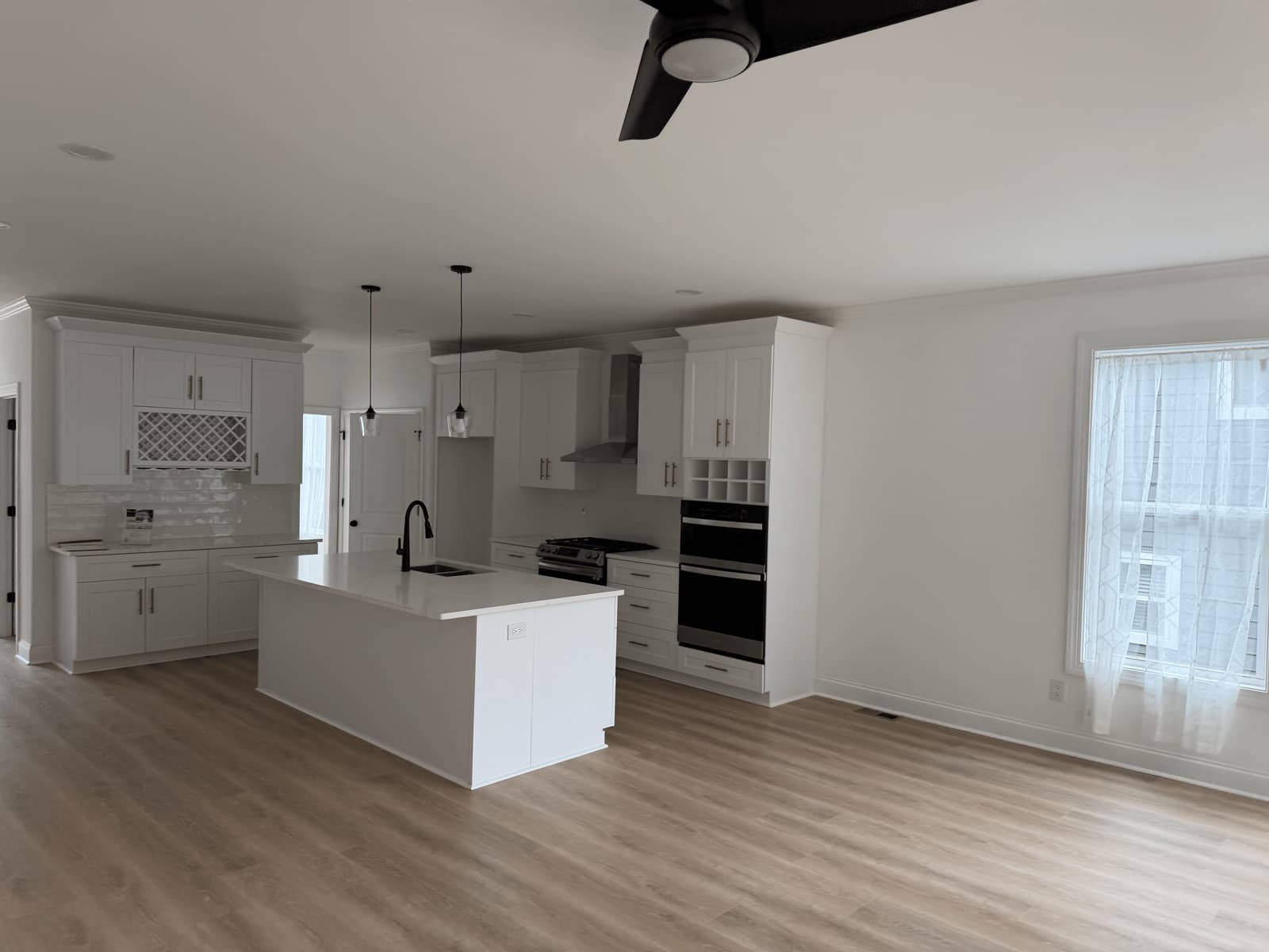 Empty open-plan kitchen and living area after a move-out clean